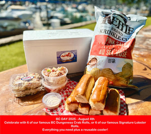 Outdoor setting with food items including a cooler, crab rolls, lobster rolls, and potato chips.
